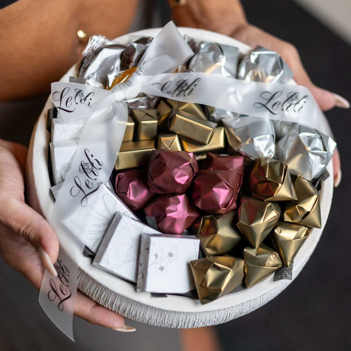 The Ivory Ribbed Bowl, the LARGE size, top view of the chocolate arrangement